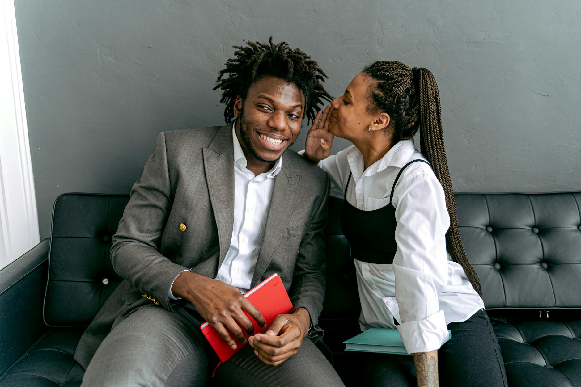 a woman whispering to a man