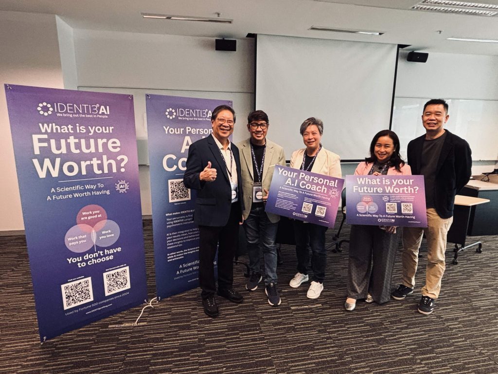 IDENTI3 team at the SUSS career fair beside personality profiling and AI coaching displays.